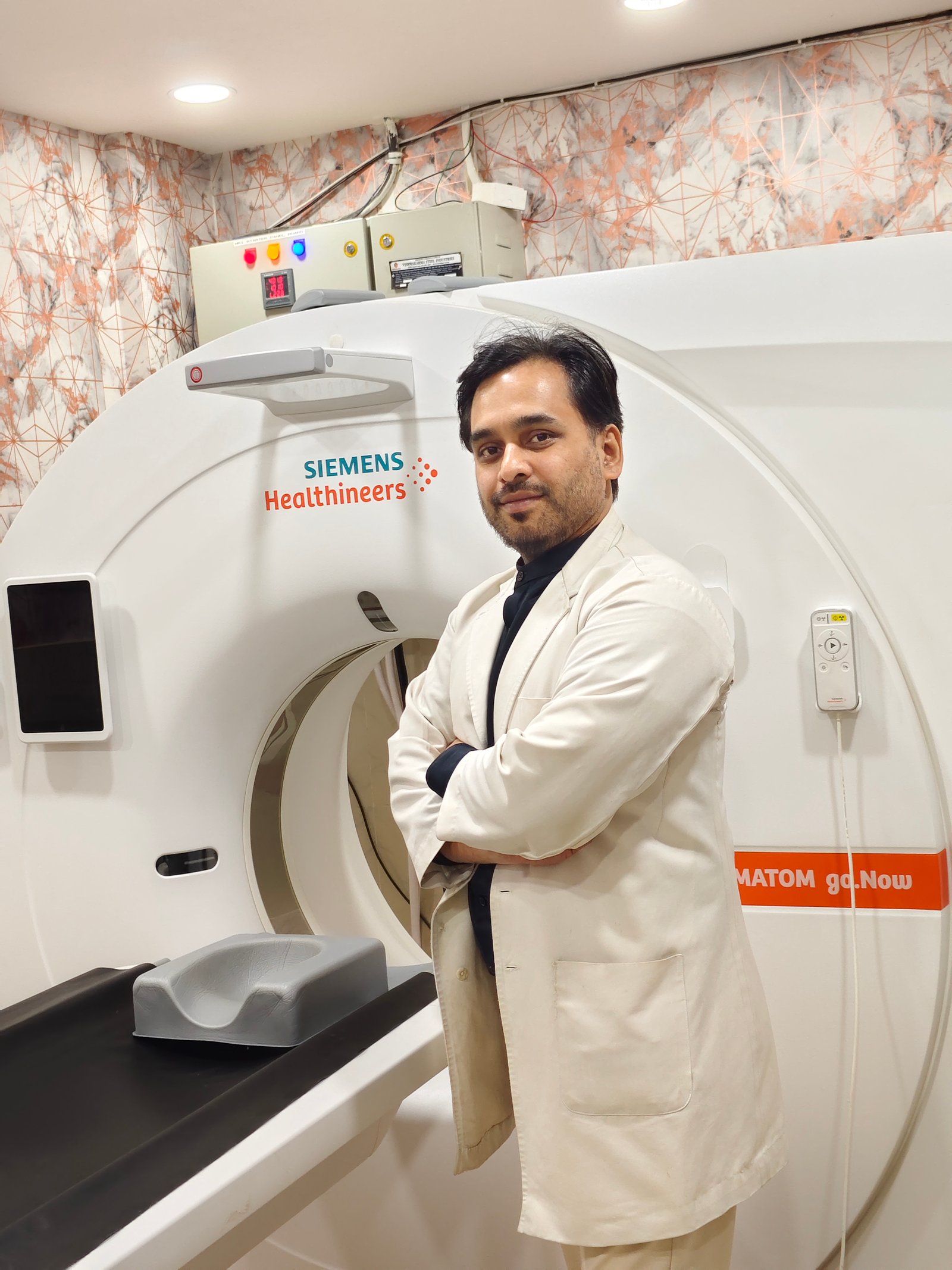 Dr. Manish Meshram with the CT scanner at Meshram Diagnostics